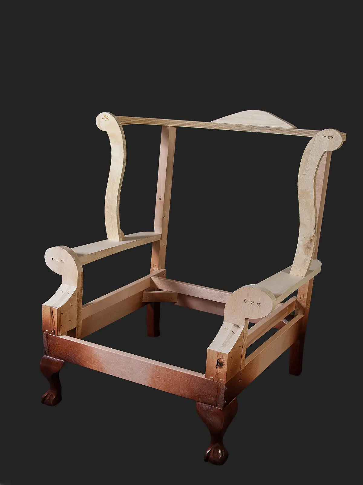 A partially assembled wooden chair frame showing its structure and design detail.