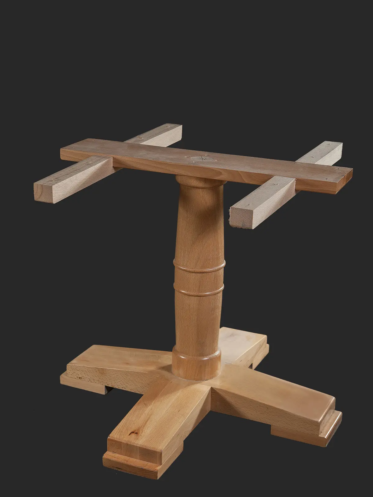 A wooden table base featuring a cross design and a cylindrical support, ideal for DIY furniture projects.