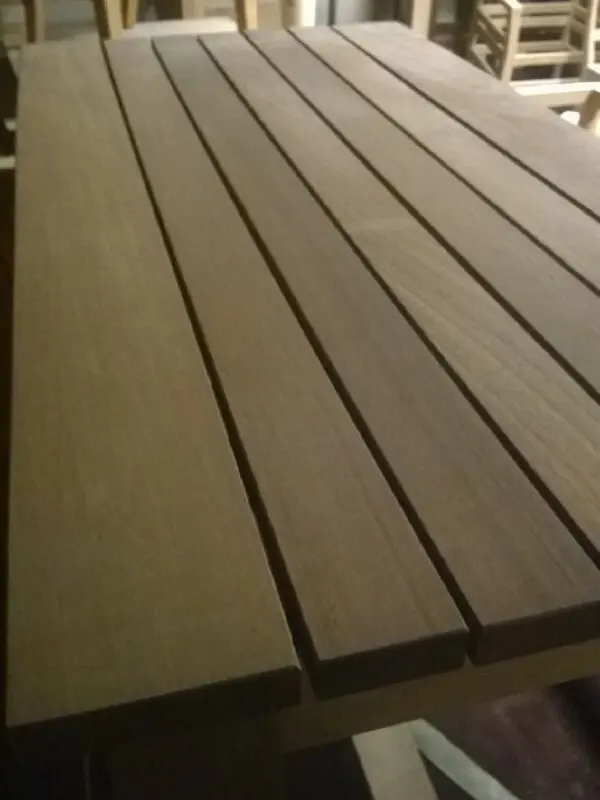 A detailed view of wooden slats on a table surface, showcasing the natural grain and texture of the wood.