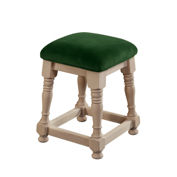 A wooden stool with a green upholstered seat and decorative carved legs.