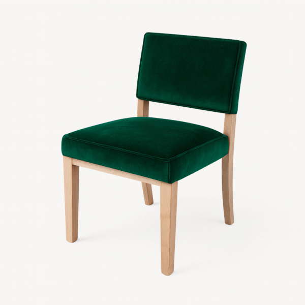 A stylish green velvet chair featuring a minimalist design and light wooden legs, ideal for modern interior decor.