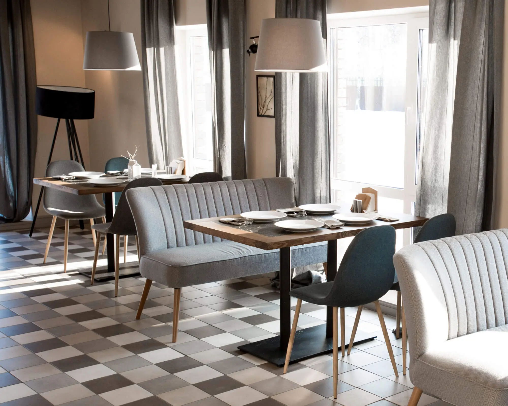 Stylish Modern Restaurant Interior Design Elegant dining area with modern furniture, checkered floor, and large windows