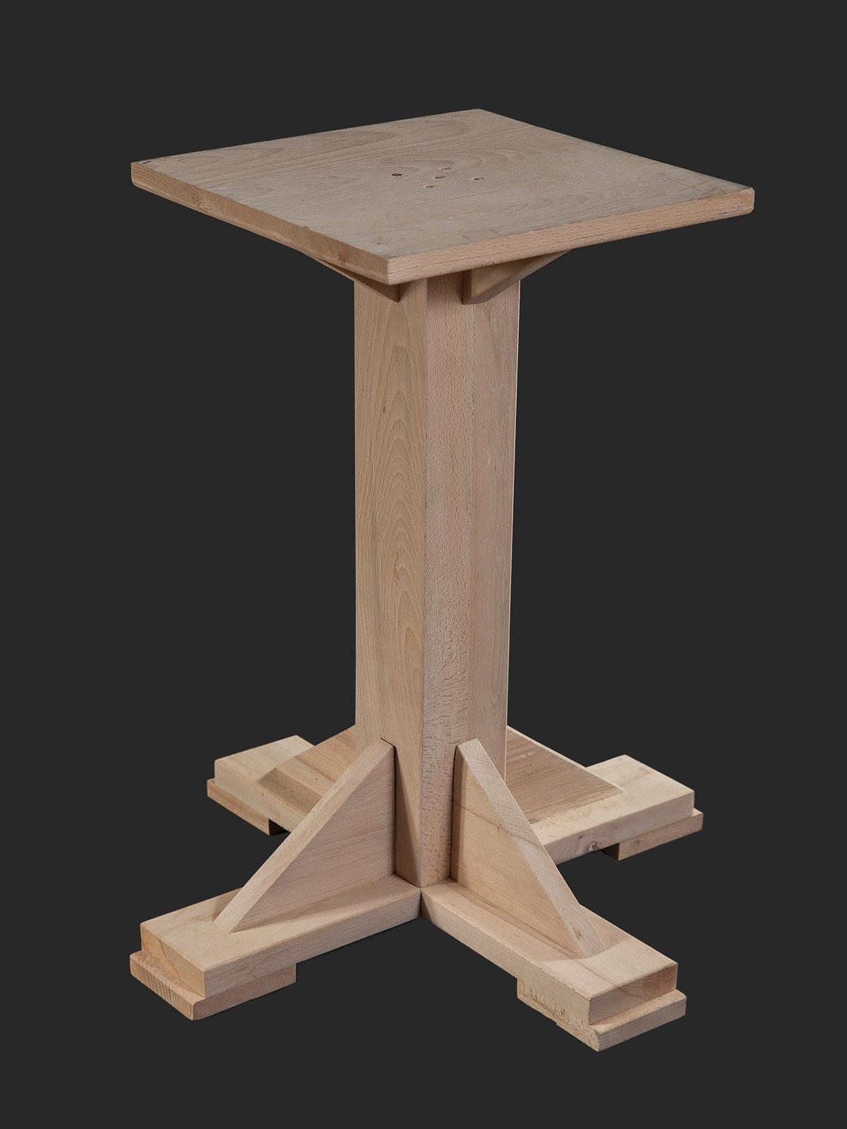 A wooden display stand featuring a square top and a sturdy cross-shaped base, designed for showcasing items.