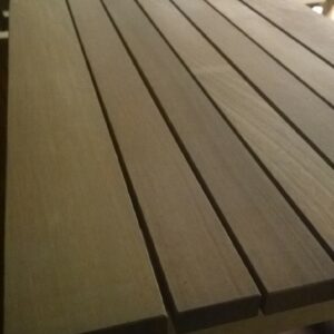 A detailed view of wooden slats on a table surface, showcasing the natural grain and texture of the wood.