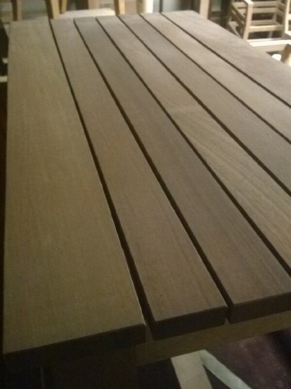 A detailed view of wooden slats on a table surface, showcasing the natural grain and texture of the wood.
