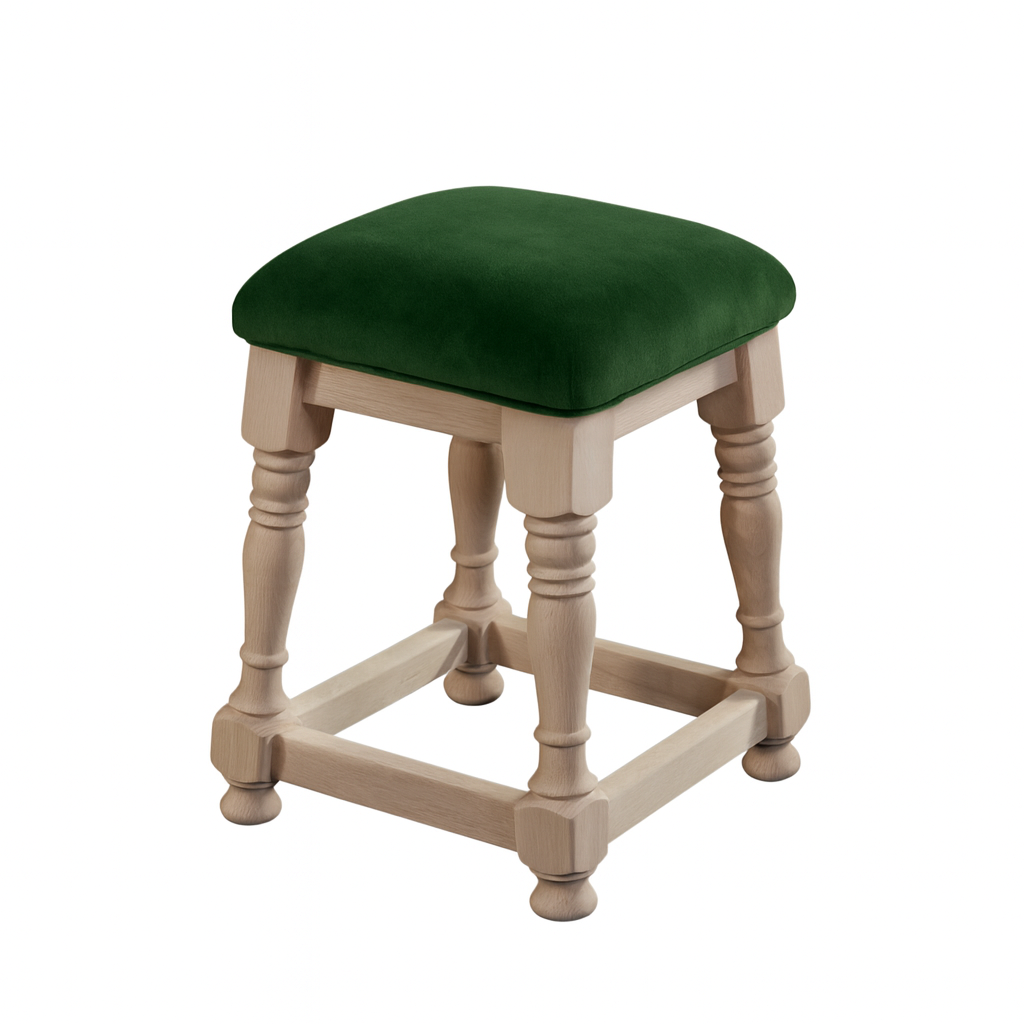 A wooden stool with a green upholstered seat and decorative carved legs.