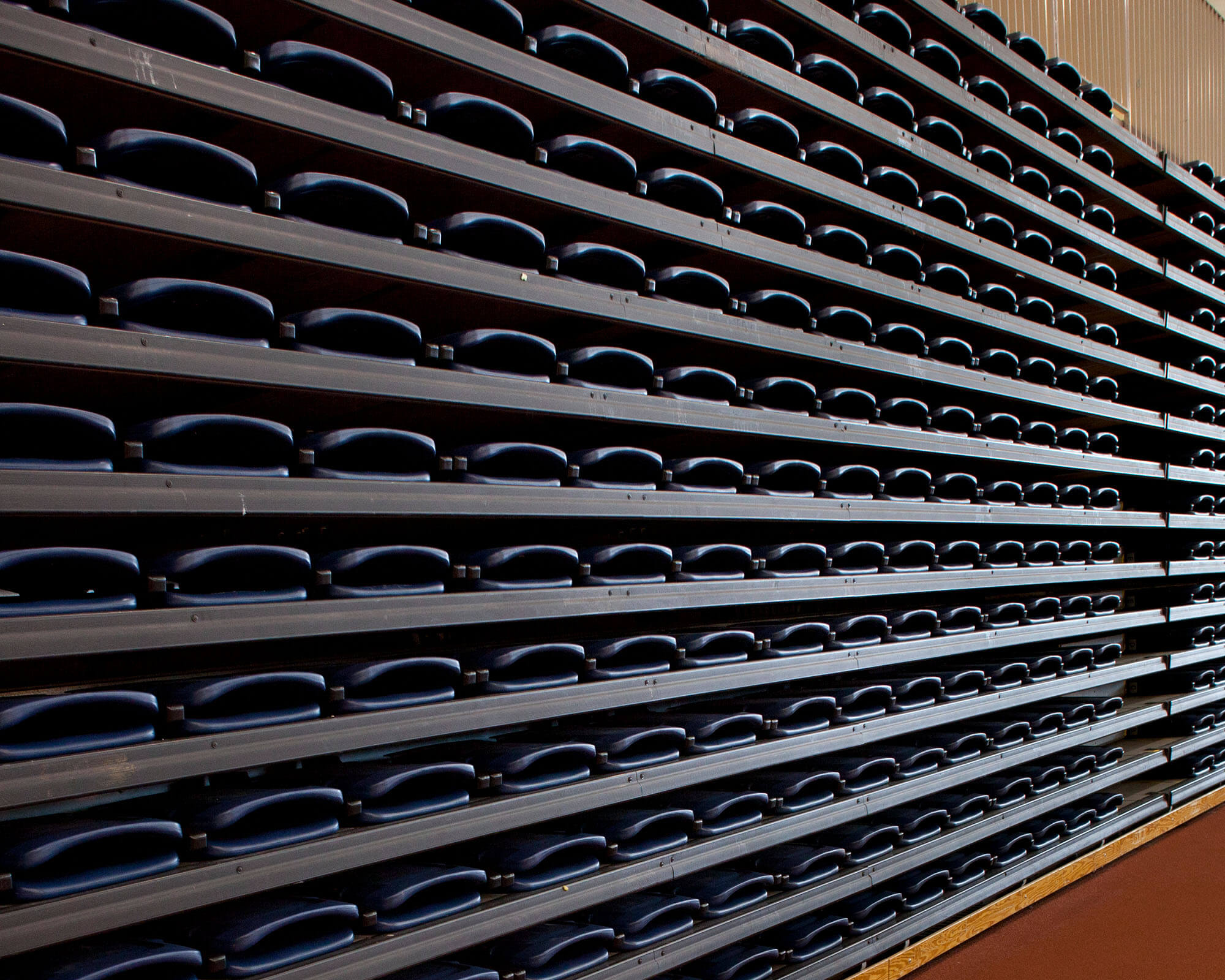 a-row-of-folded-seats-in-an-indoor-sports-venue