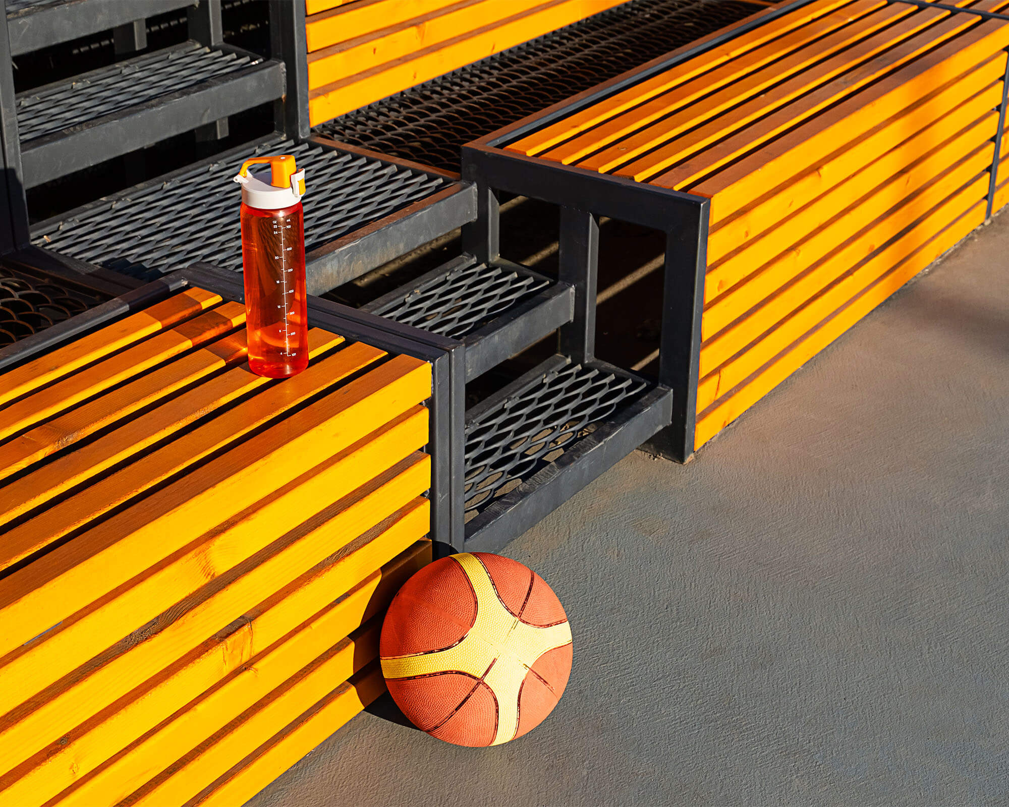 basketball-and-water-bottle-on-wooden-bench-at-out